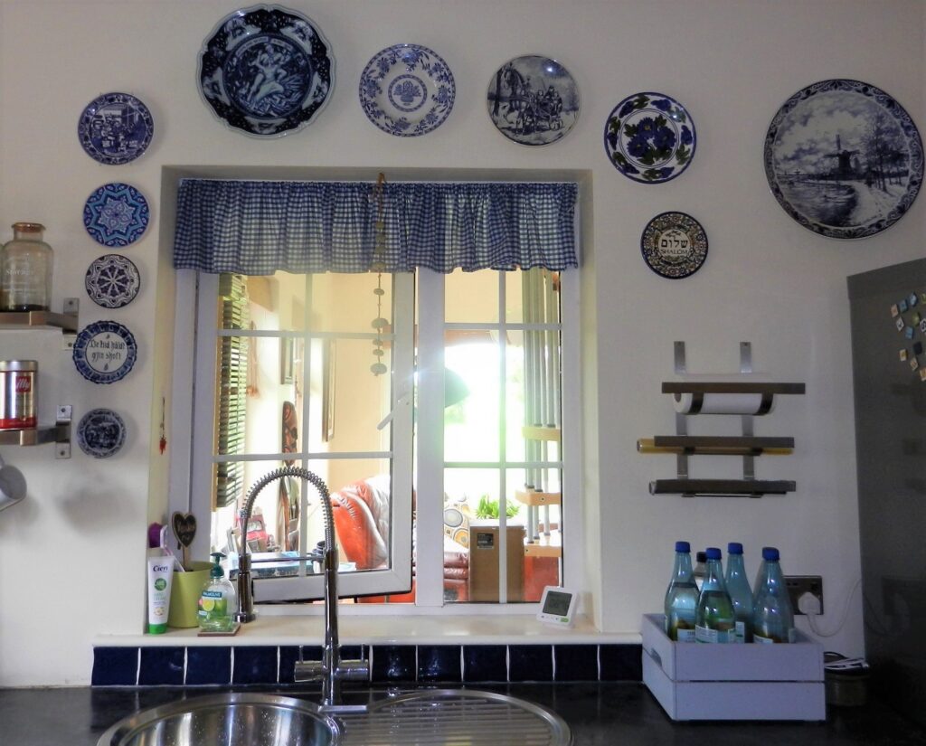 Organise your wall decor, blue tiles against the wall.